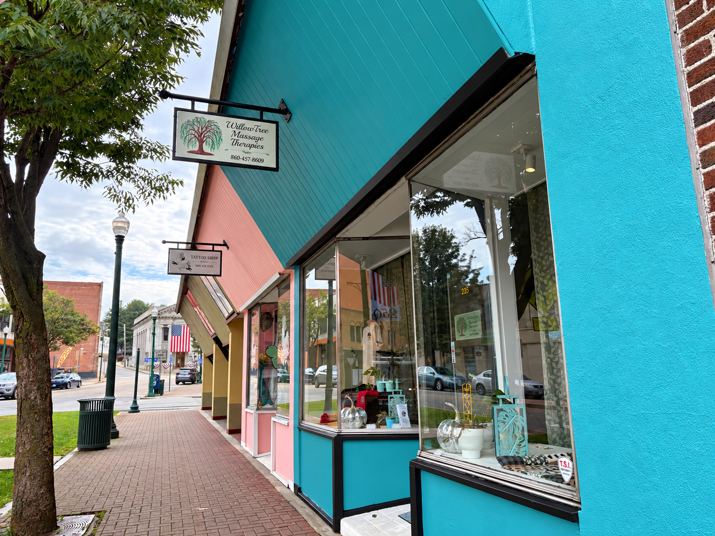 Willow Tree Massage Therapies storefront on Main Street in Norwich, with a turquoise facade and hanging business sign.
